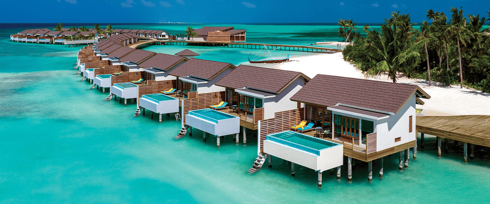 atmosphere kanifushi maldives aerial view water villa jetty 03 v2