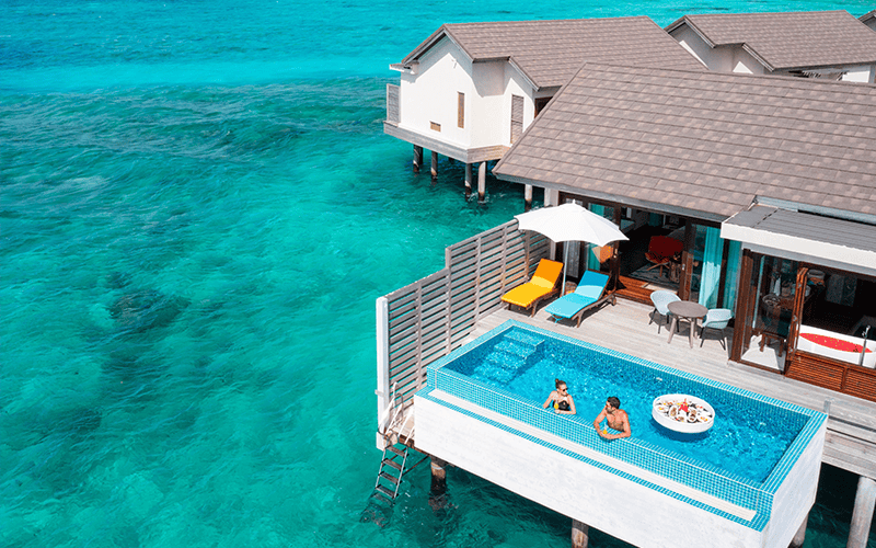 atmosphere kanifushi maldives sunset water villa with pool aerial floating breakfast lifestyle 01 09 2023 v2