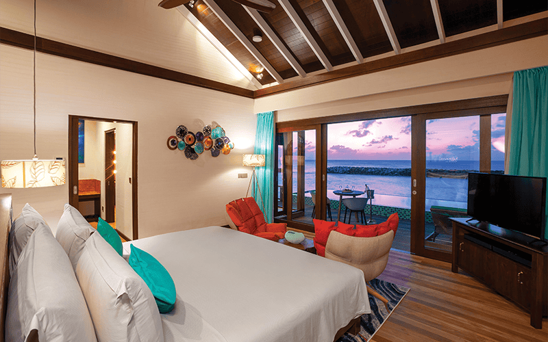 atmosphere kanifushi maldives water villa with pool sunset from bedroom v2