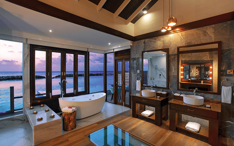 atmosphere kanifushi maldives water villa with pool sunset view from bathroom v2