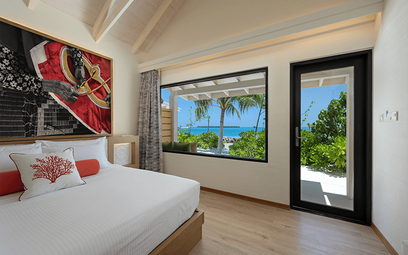 oblu xperience ailafushi beach villa bedroom with view 2 compressed