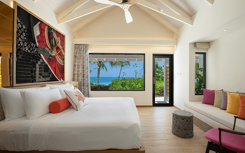 oblu xperience ailafushi beach villa bedroom with view compressed